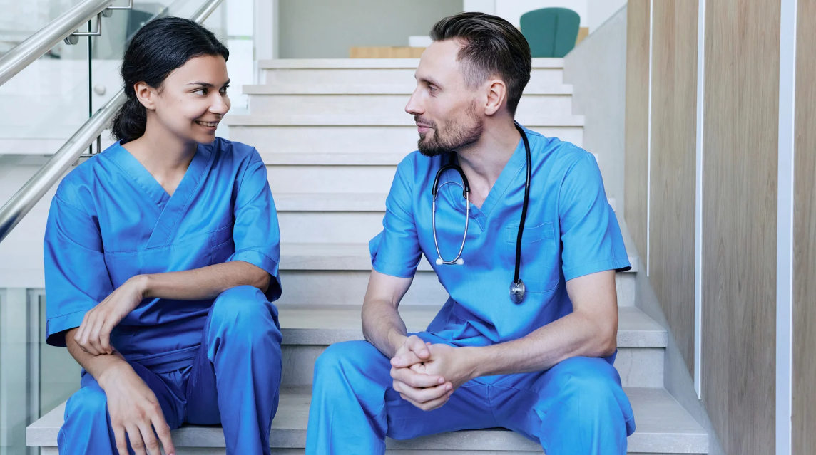 Nurses talking and demonstrating a friendly working relationship.