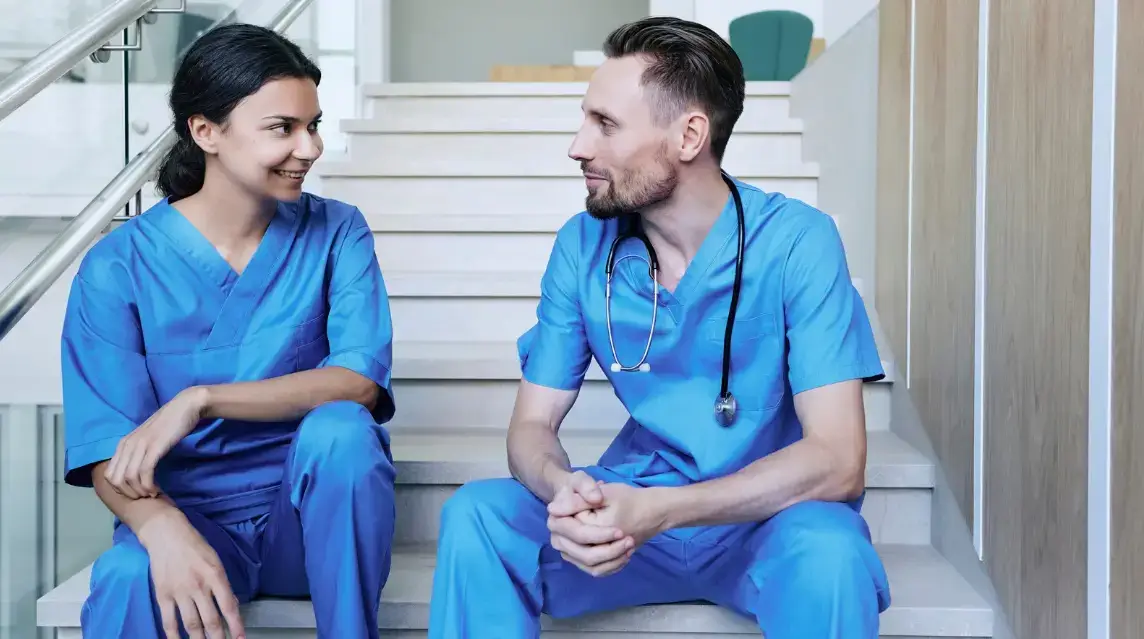Nurses talking and demonstrating a friendly working relationship.