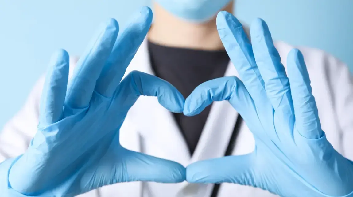 Hands forming a heart symbol to represent caring for the caregivers.