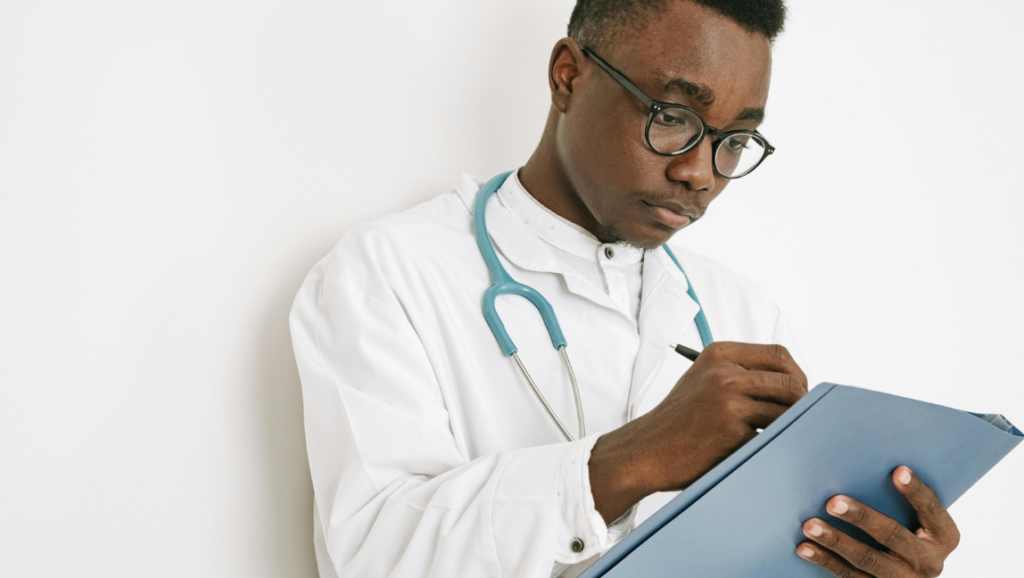 A nurse thoughtfully writing notes on a clipboard, capturing important details for patient care excellence.
