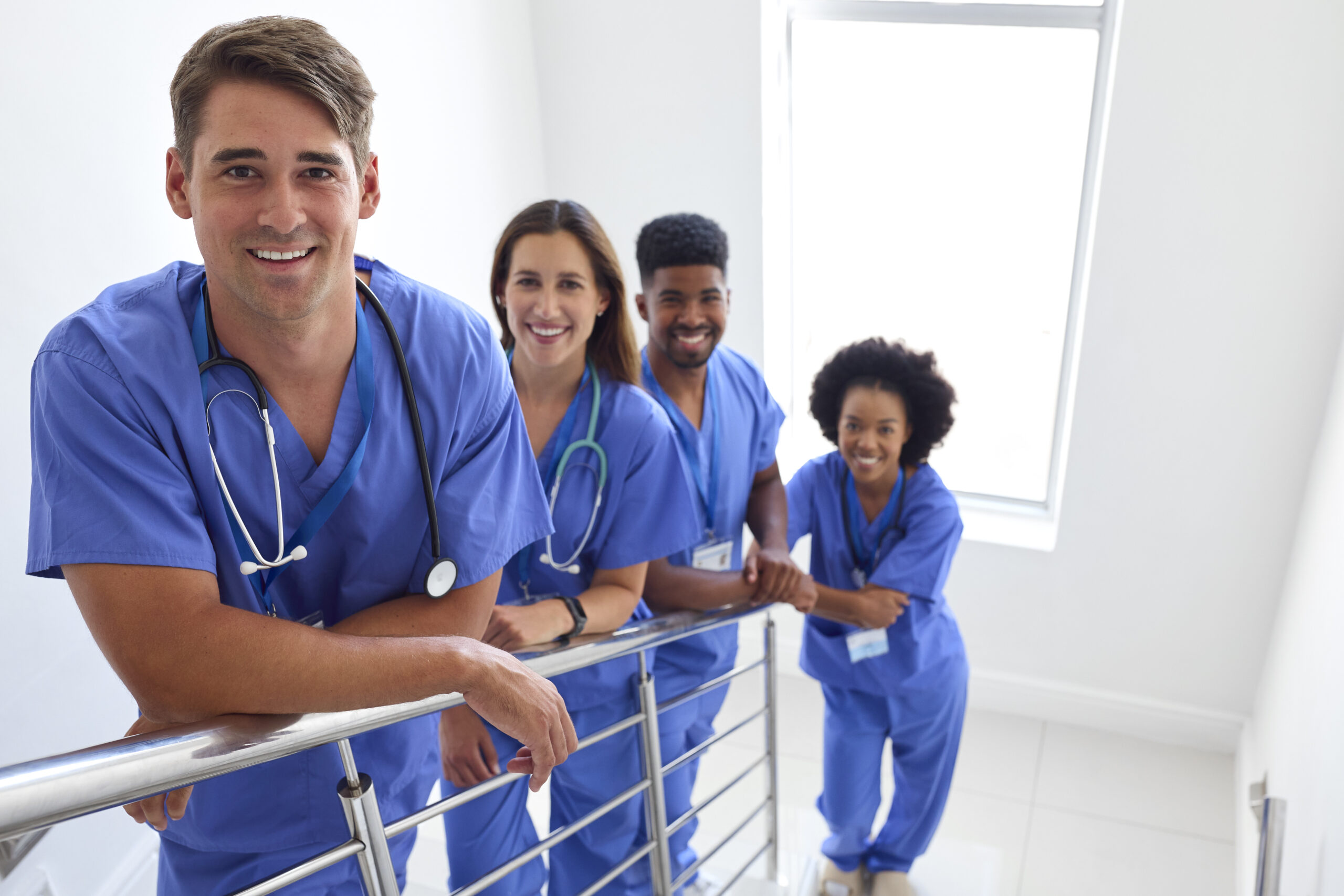 Portrait Of Multi Cultural Medical Team Wearing Scrubs Standing