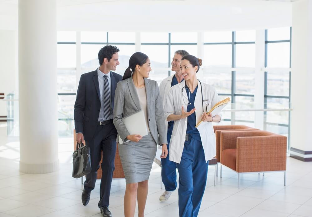 Two doctors guide two appraisers on the site visit phase of the Magnet Recognition process.