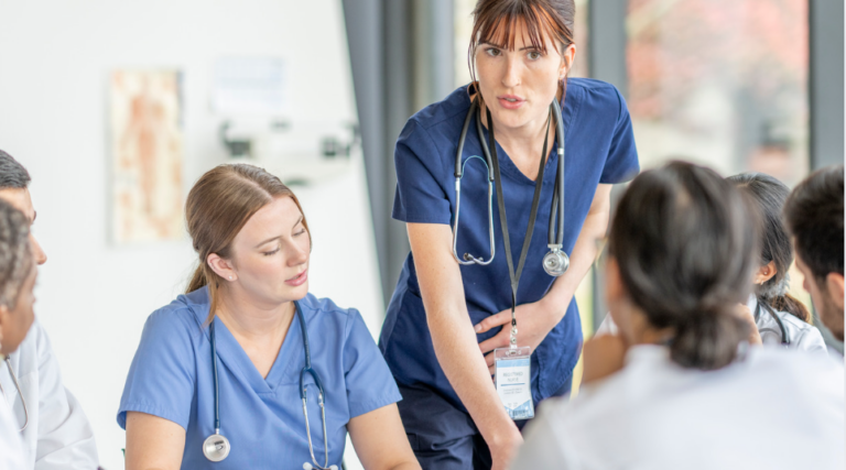 Nurse leading a professional practice discussion with healthcare team members