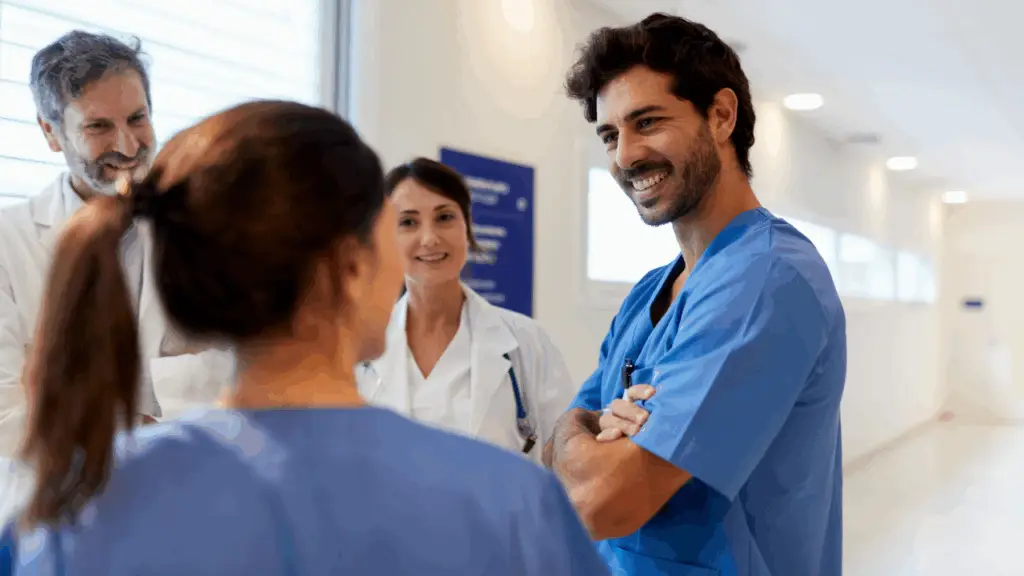 Engaged health care employee collaborating with colleagues in a hospital setting