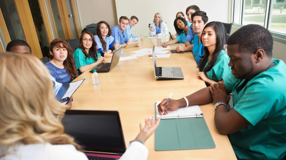 Interprofessional team discussing practice improvements through shared governance.