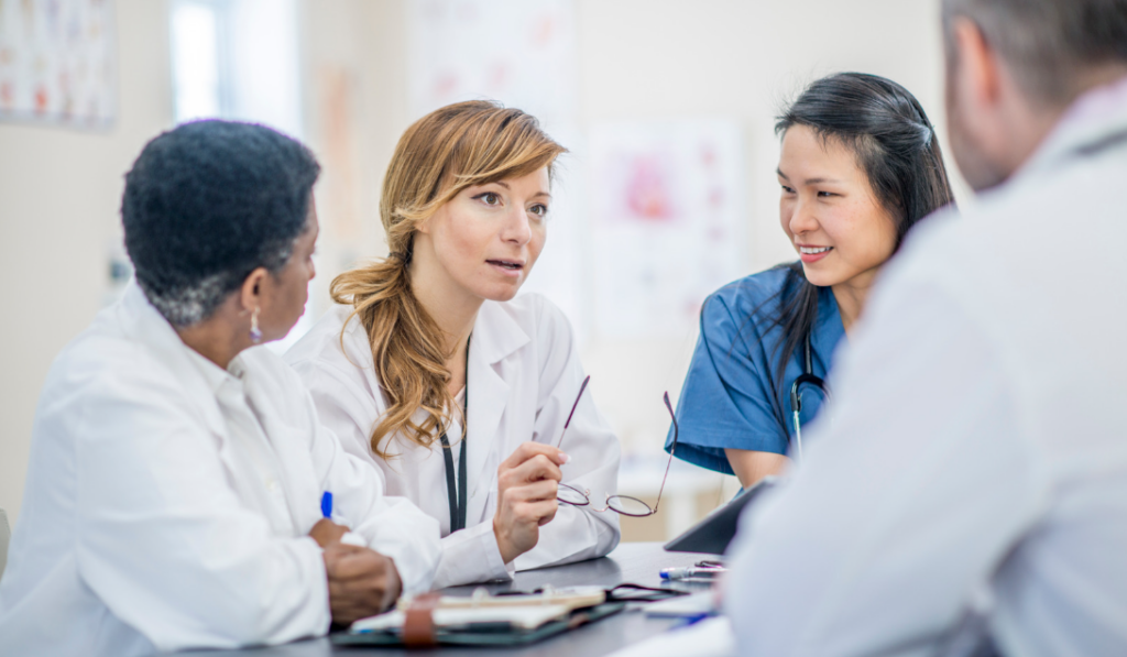 Nurse leader collaborating with staff nurses on a nursing research project in a healthcare organization | CHCM 
