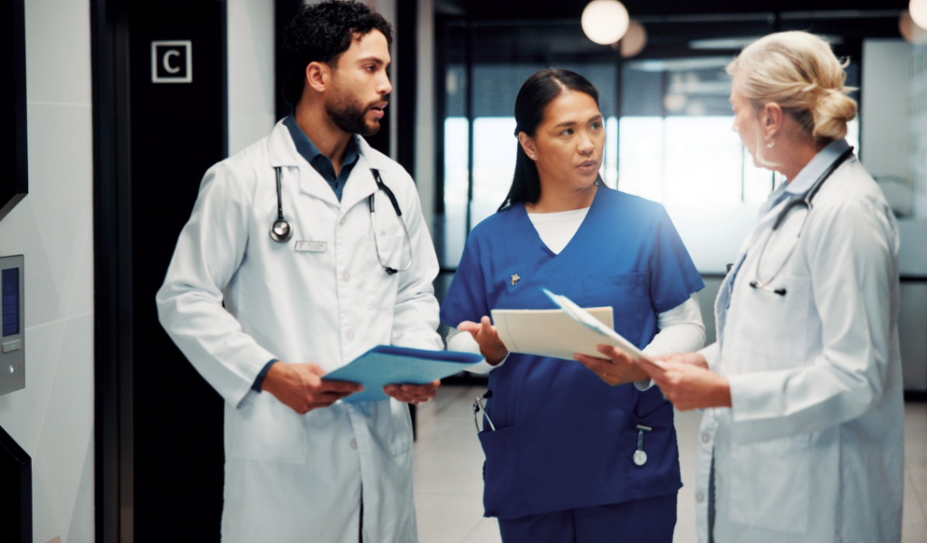 Nurse leader discussing patient experience and healthcare data insights with point of care team members | CHCM 