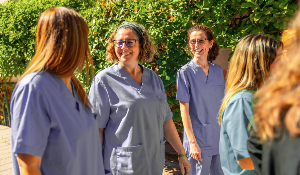 Healthcare leaders walking together through a forest illustrating leadership development inspired by nature. | CHCM 