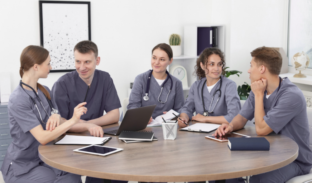 Healthcare leader facilitating psychological safety during a team discussion in a hospital setting. | CHCM 
