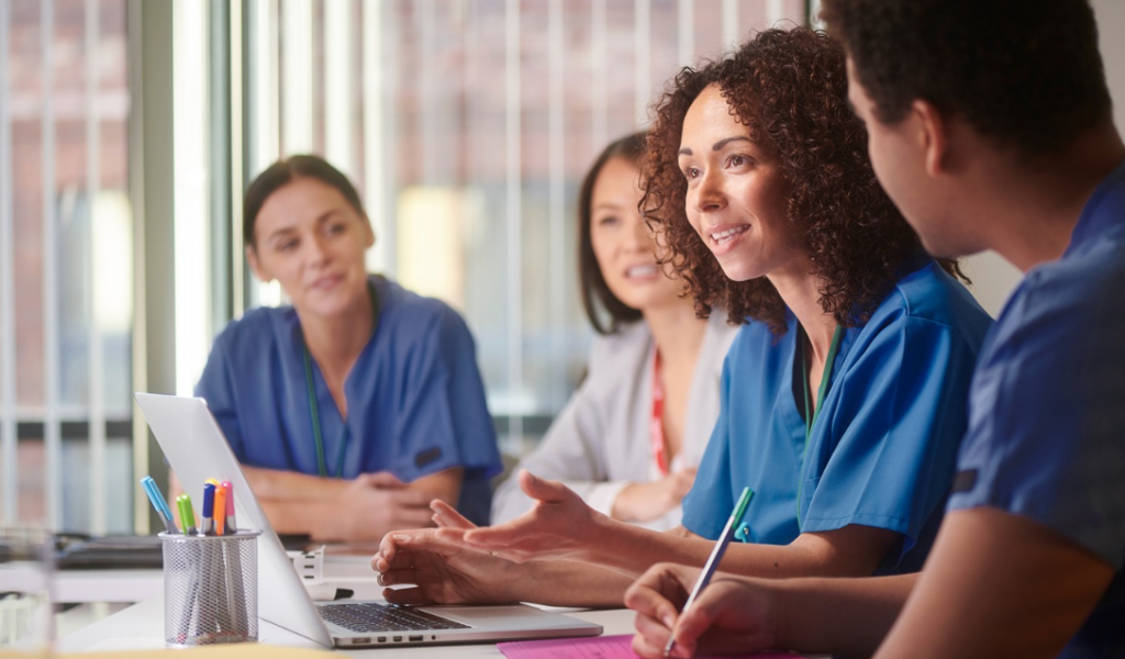 Healthcare leader meeting with nursing staff to discuss workplace concerns and nurse engagement. | CHCM