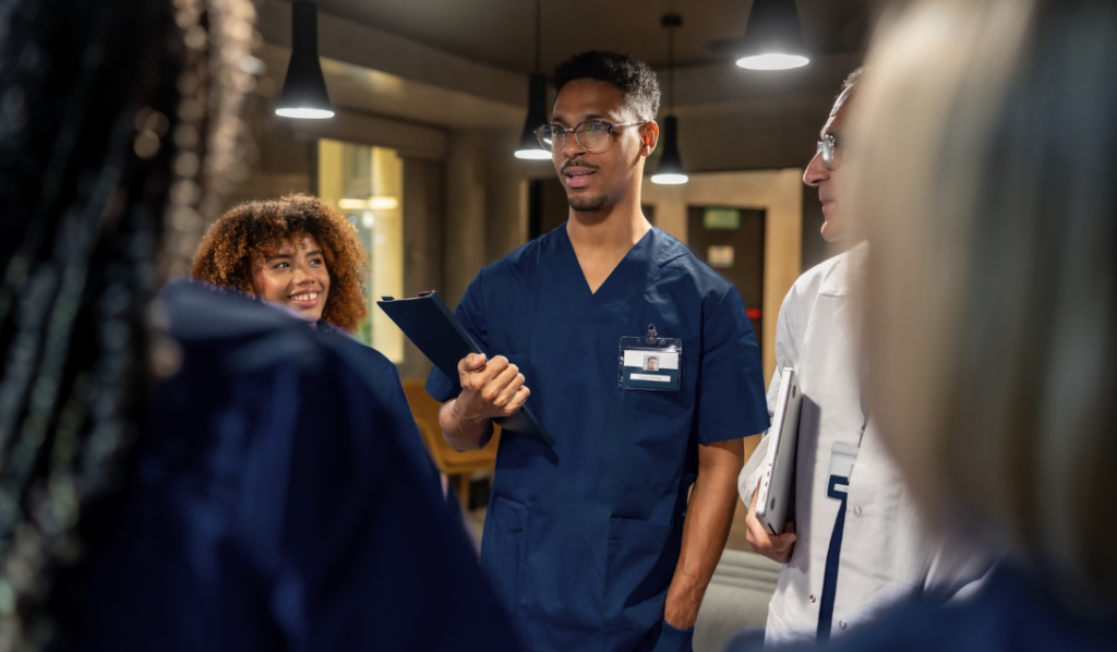 Hospital care team collaborating during interdisciplinary patient rounds. | CHCM
