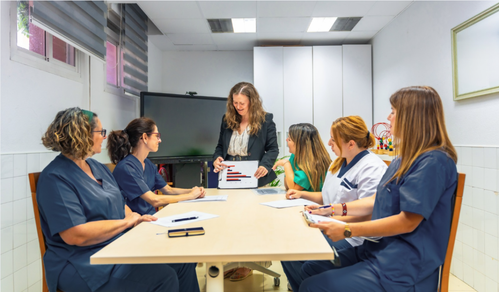 Nurse leader discussing healthcare metrics with point-of-care teams | CHCM 