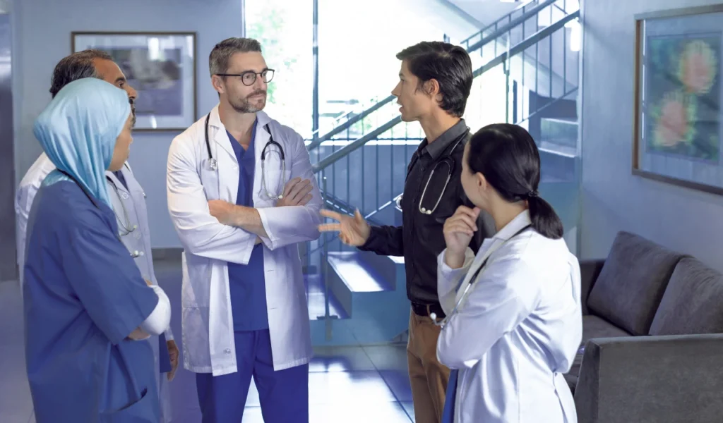 Interprofessional healthcare team communicating to coordinate safe, patient-centered care | CHCM