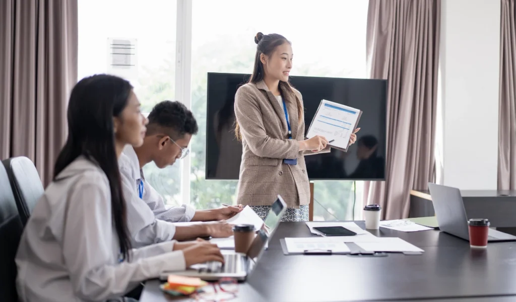 Healthcare team sharing key takeaways during a post-conference debrief  | CHCM