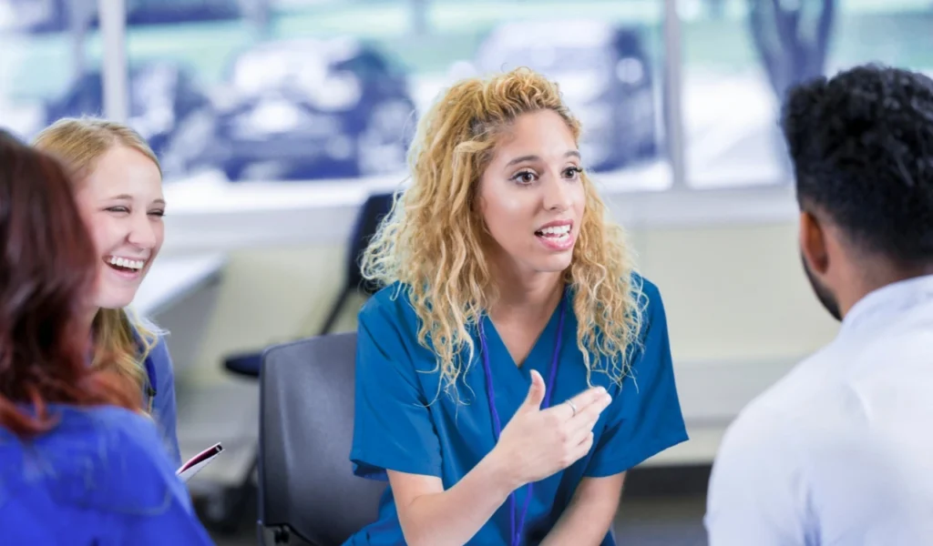 Nurses and a nurse leader discussing priorities during a professional governance council meeting | CHCM