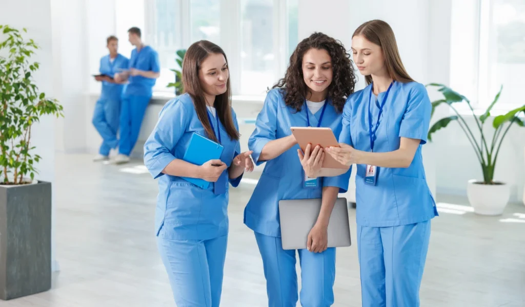 Nurses discussing professional practice and unit outcomes during Magnet® site visit preparation | CHCM