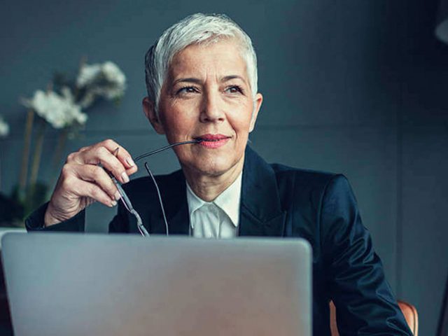 Health care consulting partner sits at a laptop