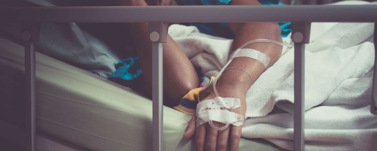sick woman lying in bed in hospital.
